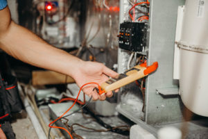 HVAC technician repairing furnace