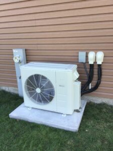 Ductless mini-split unit located on exterior side of house