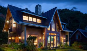 Exterior of a house at night lit up with lighting