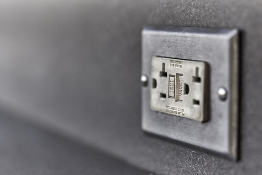 Used Ground fault circuit interrupter electrical wall outlet with shallow depth of field