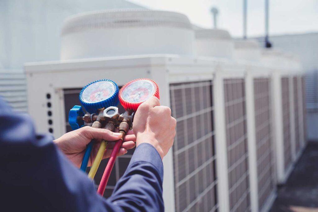 Commercial HVAC tech using pressure gauge