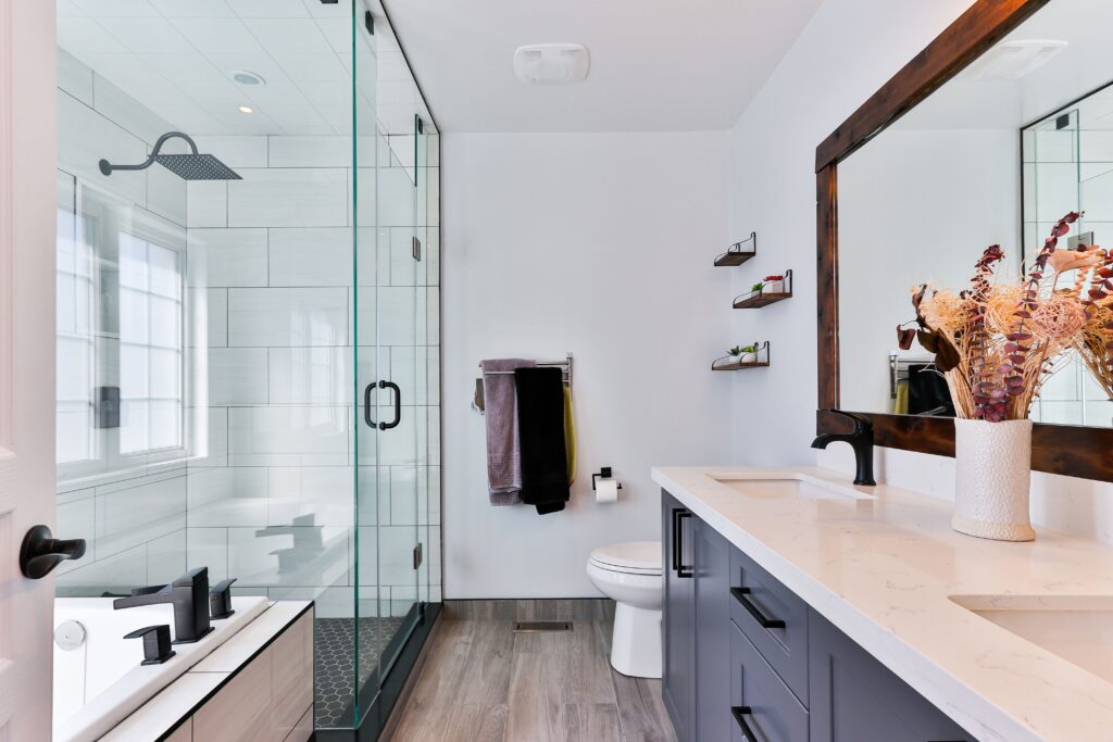 Wide shot of modern bathroom with white walls and a glass shower